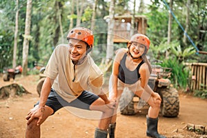 happy asian couple streching their bodies before start the atv tour