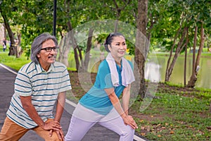 They are happy Asian couple.They  are warm up for exercise in park.