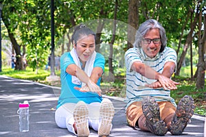 They are happy Asian couple.They  are warm up for exercise in park.