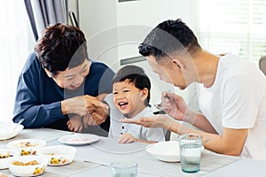 Happy Asian extended family having dinner at home full of laughter and happiness.