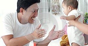 Happy asian family baby with parent make fun at home with smile face