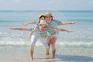 Happy asian family on the beach