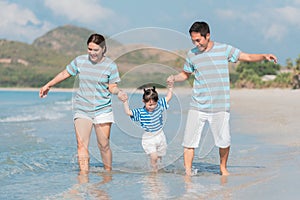 Happy asian family on the beach