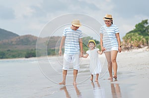 Happy asian family on the beach.