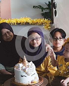 Happy Asian family celebrating birthday together at home