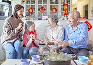 Happy asian family celebrating chinese new year at home