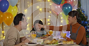 Happy Asian family enjoying christmas dinner together.