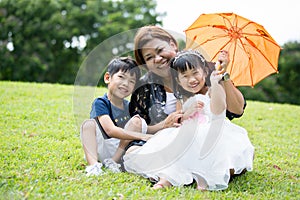 Happy Asian Family Enjoying Day In Park