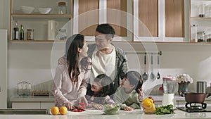 happy asian family enjoying time together in kitchen at home