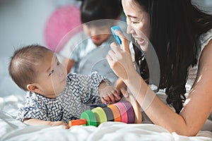 Happy asian family father mother with daughter looking camera wi