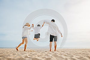 Happy Asian family have fun and live healthy lifestyle together on beach