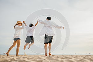 Happy Asian family have fun and live healthy lifestyle together on beach