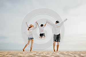 Happy Asian family have fun and live healthy lifestyle together on beach