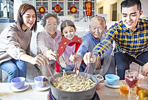 Happy asian family having dinner and celebrating chinese new year at home