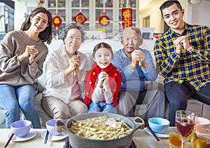 Happy asian family having dinner and celebrating chinese new year at home