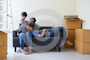 Happy Asian family having fun during moving day and relocating at new home.