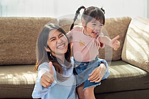 Happy Asian family kid and her sister having fun in their house, love and happiness people concept