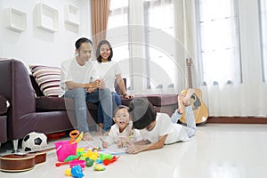 Happy asian family in living room at home