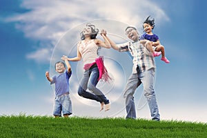 Happy Asian Family in Meadow