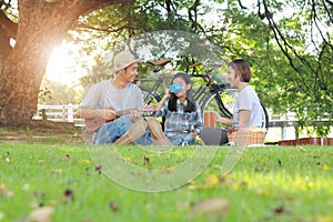 Happy asian family picnic in the park togetherness