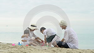 Happy asian family playing on the beach in summer together with fun, parents and kid leisure with enjoy