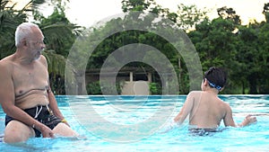 Happy asian family playing in pool.