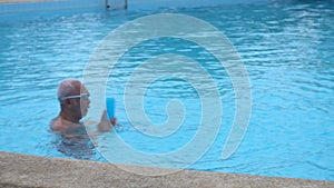 Happy asian family playing in pool.