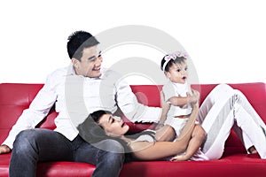 Happy asian family playing on sofa