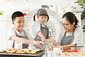 Happy Asian family preparing the dough.