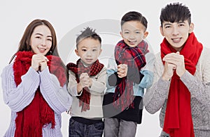 Happy asian family showing congratulation gesture for celebrating Chinese new year