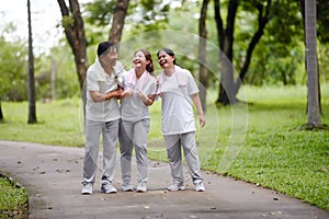 Happy Asian Family Showing Each Other Love and Concern in the Park while Walking for Exercise. Family Bonding Without Bounds,