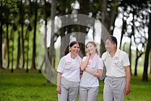 Happy Asian Family Showing Each Other Love and Concern in the Park while Walking for Exercise. Family Bonding Without Bounds,