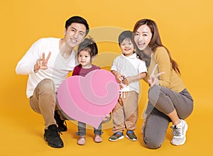 Happy asian family showing the  heart and love shape sign