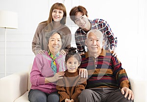 Happy asian family on sofa