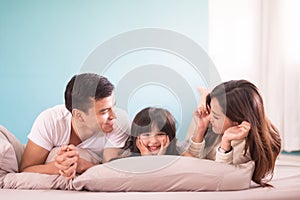 Happy asian family spending time together in bedroom. family and home concept.