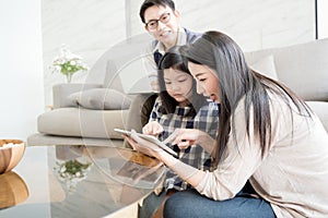 Happy asian family spending time together in living room. family and home concept.