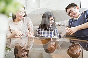 Happy asian family spending time together in living room. family and home concept.