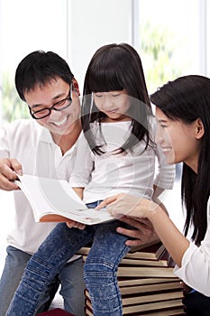 Happy asian family studying together