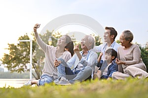 Happy asian family taking a selfie photo