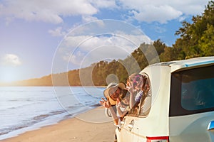 Happy Asian family with trip car travel having fun and enjoying on beach in summer vacation holiday