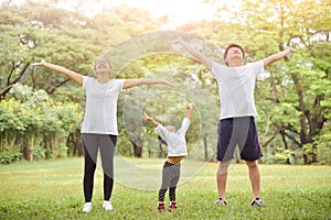 Happy Asian family workout at the park.