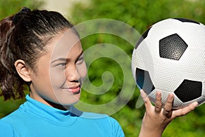 Happy Asian Female Athlete With Soccer Ball