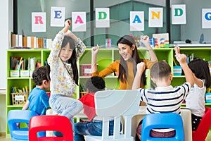 Happy Asian female teacher and mixed race kids in classroom,Kindergarten pre school concept