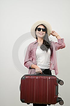 Happy Asian female tourist holding her luggage. isolated white background. vacation, holiday