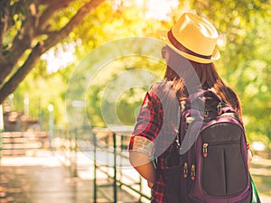 Happy Asian girl backpack in the road and forest background