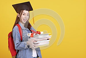 Happy Asian girl college student in Graduation cap  smiling and holding books