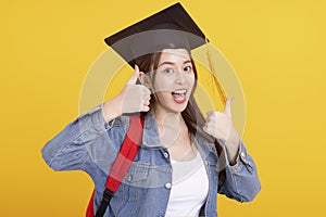 Happy Asian girl college student in Graduation cap  with thumbs up  gesture