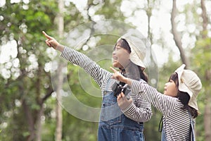 Happy Asian girl getting ready for the journey with binoculars