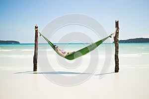Happy Asian Girl in a Hammock on a Tropical Island Beach
