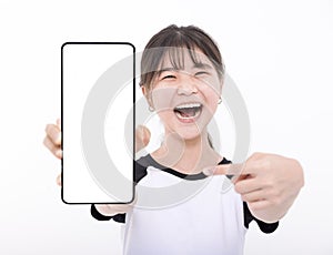 Happy Asian girl holding smartphone mockup of blank screen